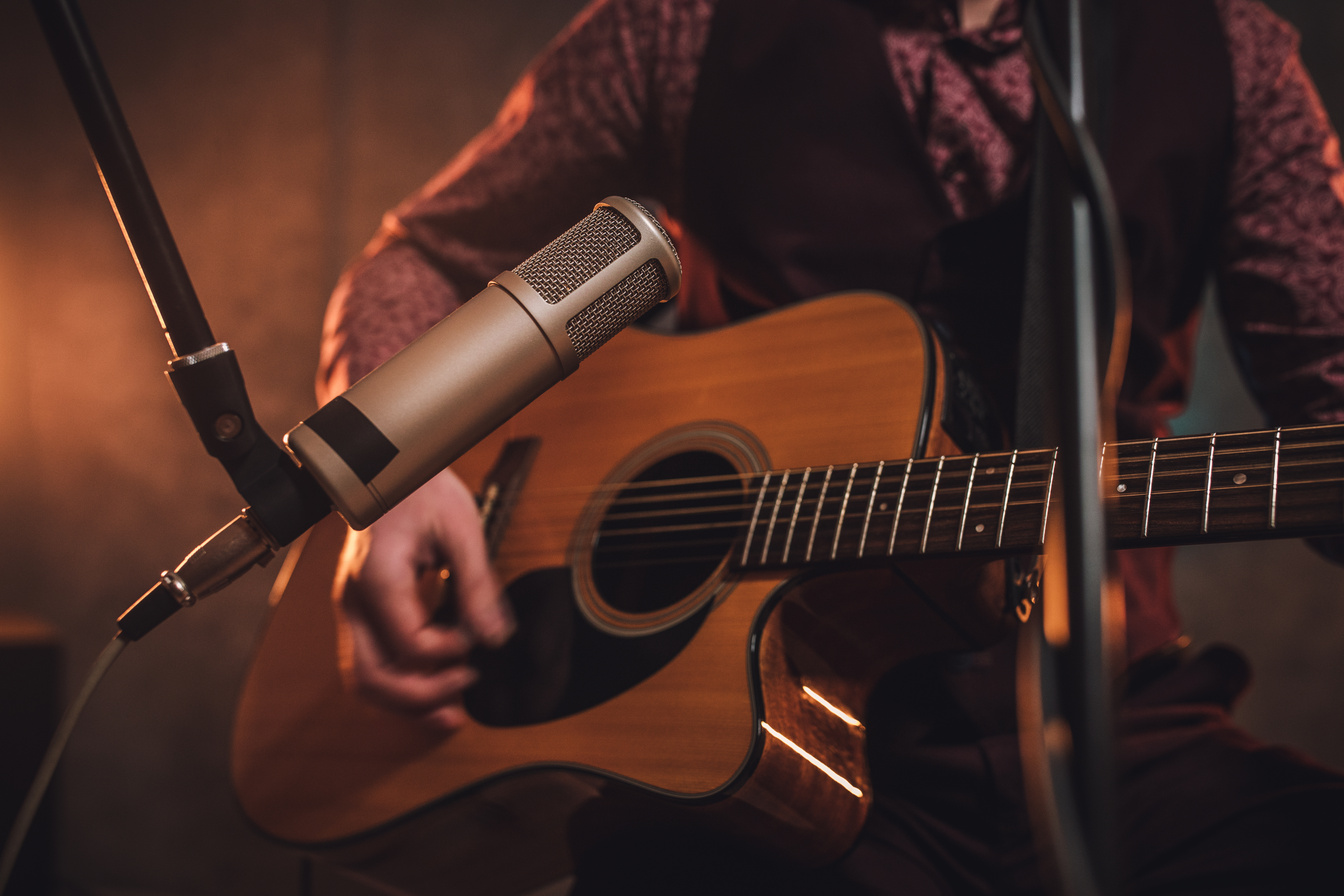 Rock musician playing acoustic guitar